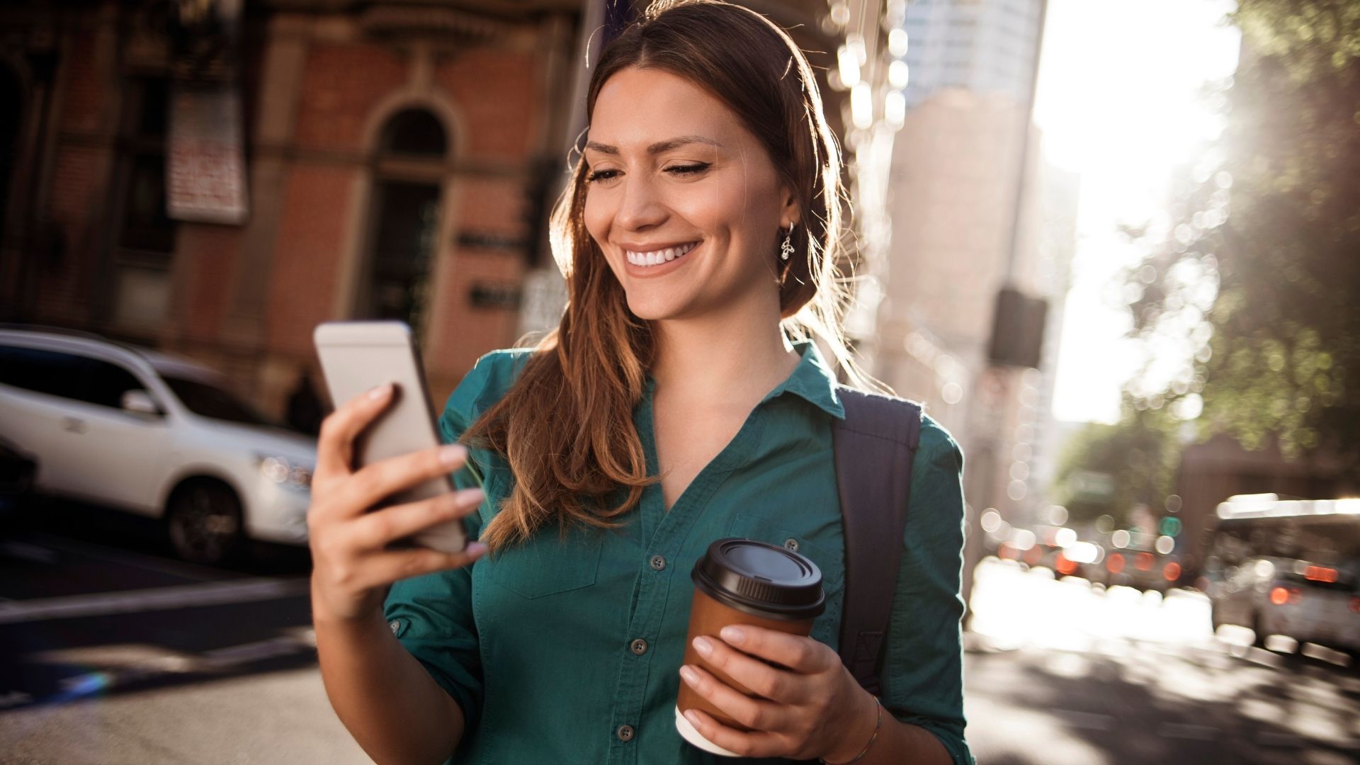 Background for 'Social engament', a woman smiling at her smartphone